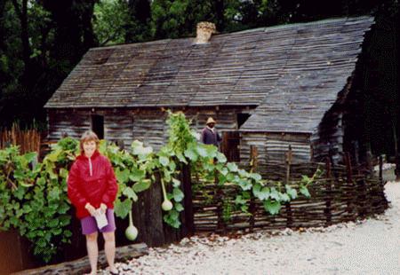 Lois in front of slave quarters.